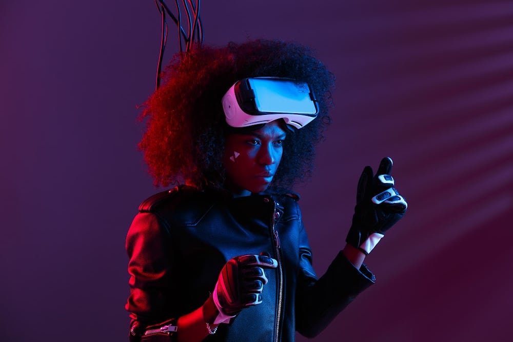 female gamer wearing a virtual reality headset with wires coming out of her head