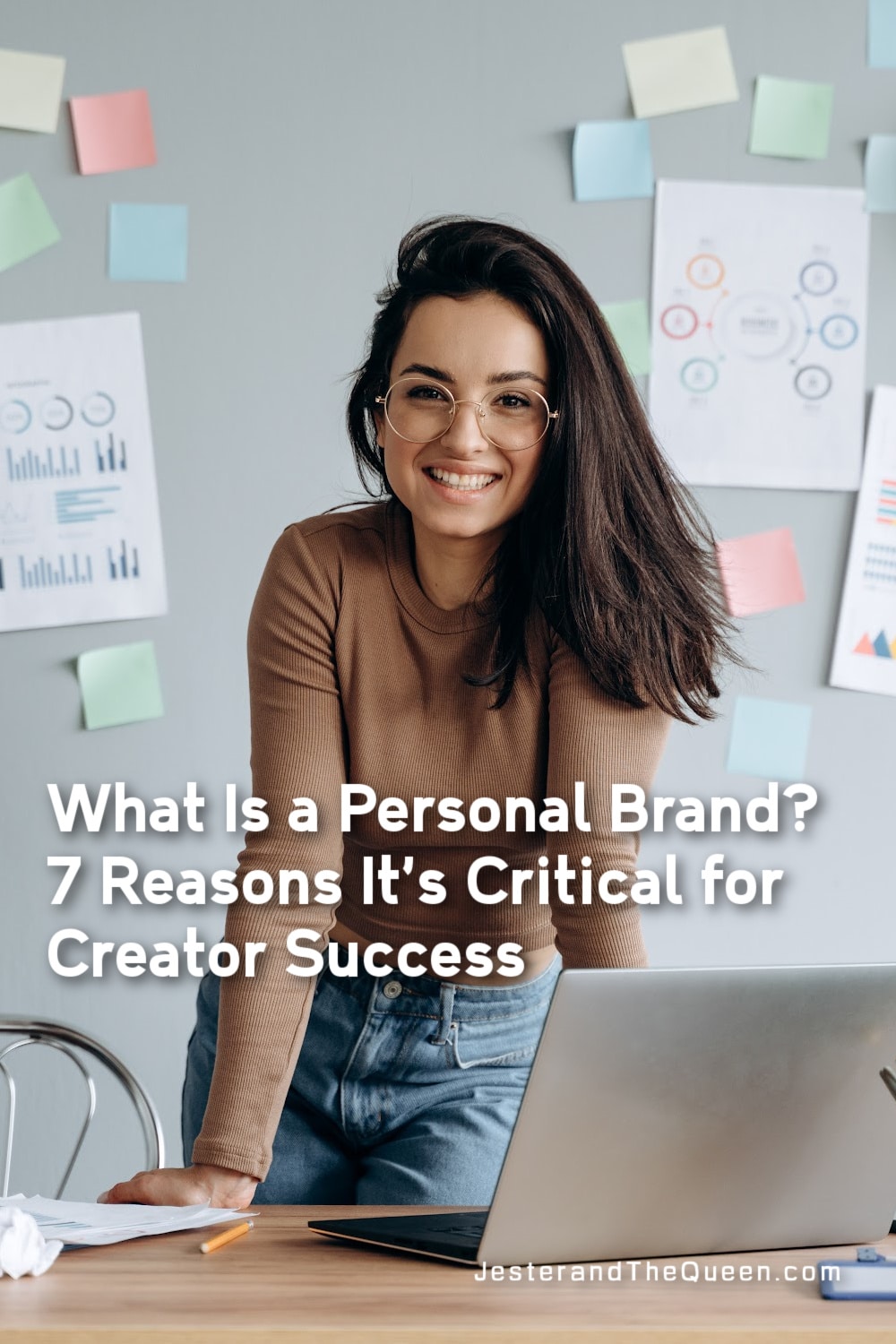 smiling woman in from of a wall of post it notes leaning on a desk with a laptop and the words What Is a Personal Brand? 7 Reasons It’s Critical for Creator Success