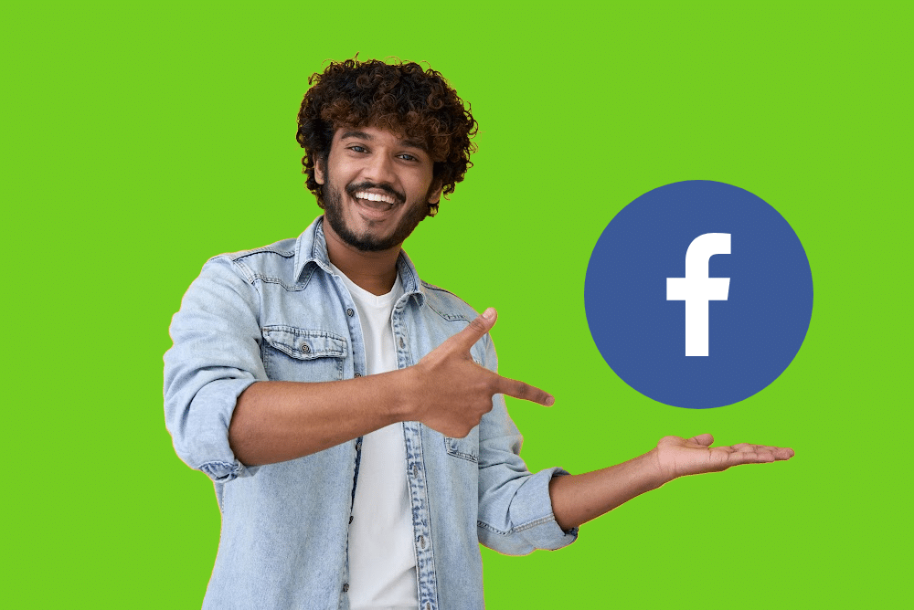 man pointing to facebook logo