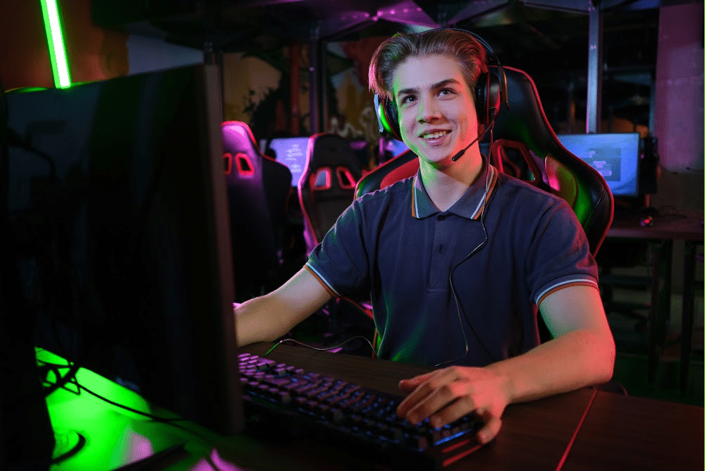 young man smiling with a gaming headset preparing his streaming channel