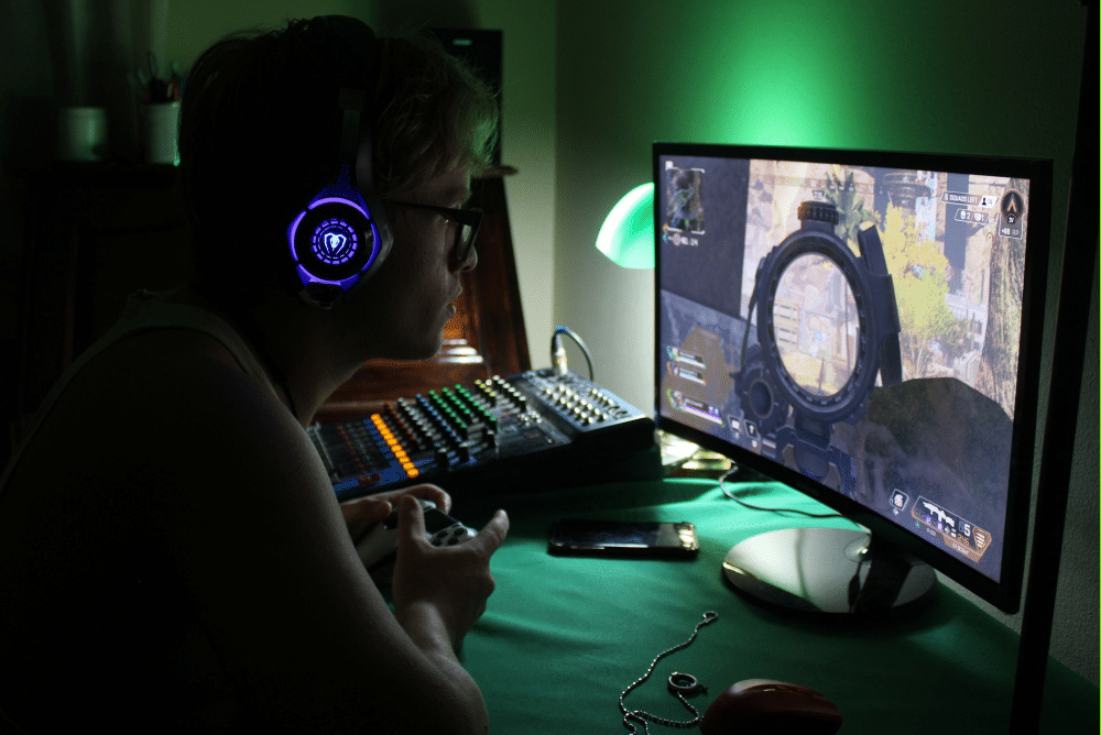 gamer with streaming gear playing a game with a controller