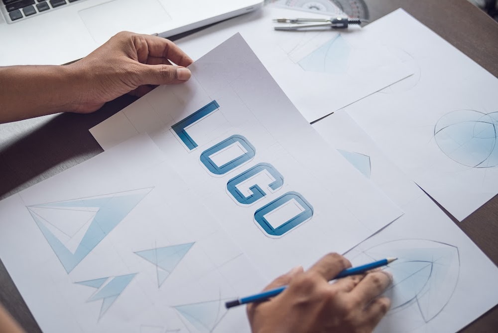 the word logo on a sheet of paper on a desk with other papers